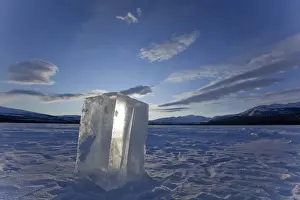 Clear ice cube on frozen Fish Lake, cut out with a chain saw, Yukon Territory, Canada