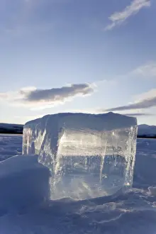 Yukon Prints: Clear ice cube on frozen Fish Lake, cut out with a chain saw, Yukon Territory, Canada