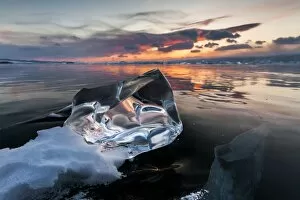Clear piece of ice at sunset