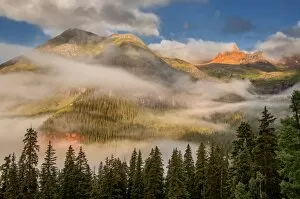 clearing undercast fog at sunrise, alpenglow
