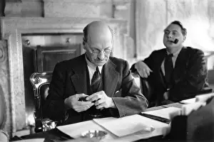 Prints of 27th July 1946: Clement Attlee (1883-1967), British Labour Prime Minister at his desk with press adviser Francis Williams in the background A Quiet Strength: A Leader Who Shaped Modern Britain: Clement Attlee