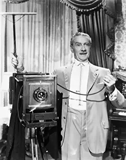 Flash Prints: Clifton Webb Taking Picture in Sitting Pretty