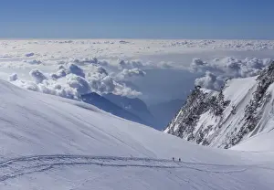 High Mountain Range Prints: Two climbers above the clouds on Monte Rosa, Alps, Valle dAosta, Italy