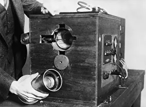 Displaying Prints: Close-up Hand Holds TV Transmitter