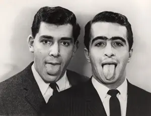 Close-up of two men with protruding tongues