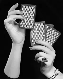 Close-up of womans hands w / playing cards