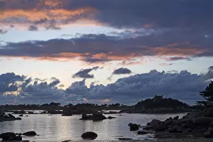 Cloud formations at sunset over the rocky bay of Sain-Guirec, Ploumanac h, Cote de Granit Rose, Brittany, France