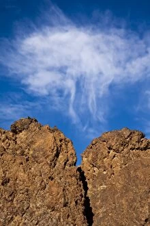 Cloud over volcanic rock formation