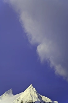 Iceberg Ice Formation Gallery: Clouds soaring in blue sky above snowy mountains