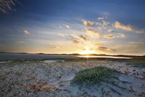 Glow Prints: Cloudy sunrise over quiet lagoon with cloud patterns and a orange glow - De Mond South Africa