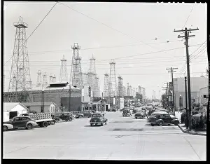 Derrick Prints: Clusters Of Oil Derricks Along Street