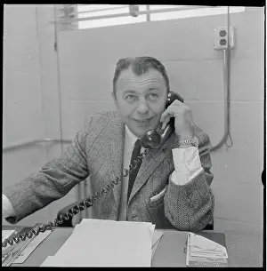 Coach John Michelson Conversing on Telephone