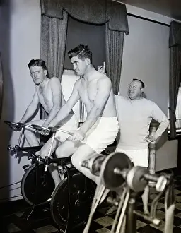 Coach And Men Riding Stationary Bikes