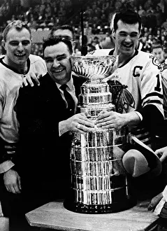 Hockey Prints: Coach and Players Embrace Stanley Cup