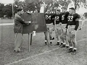 Coach Teaching Army Football Team