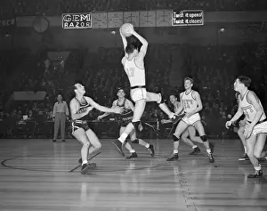 Prints of Sam Milanovich of the University of Pittsburgh Panthers jumps up with the basketball against their game with the University of Fordham Rams Hoops Through Time: A Visual Journey of Basketball History: College Basketball Game in New York