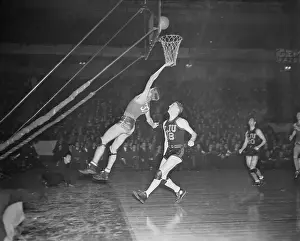 Prints of Dinty Moore of Leland Stanford University lays up as Kenny Norton of Long Island University rushes up for a possible rebound during a game at Madison Square Garden Hoops Through Time: A Visual Journey of Basketball History: College Basketball at Madison Square Garden