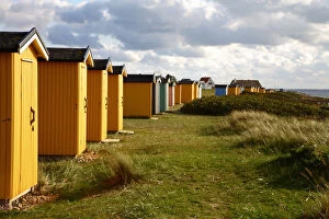Colorful huts in grassy field