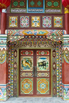 Images Dated 5th April 2010: Colorful Tibetan designs on wall and door panels of temple, Jiuzhaigou National Scenic Area