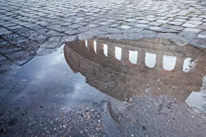 Landmark Collection: Colosseum reflected in puddle, Rome, Italy