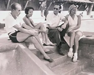 Prints of (Original Caption). Palm Springs, California: Movie Comedians and Wives, Pictured At Desert Winter Resort. Left to right Mr. and Mrs. Groucho Marx and Mr. and Mrs A Timeless Collection: Comedian Groucho Marx Relaxing and Conversing with Hollywood Friends