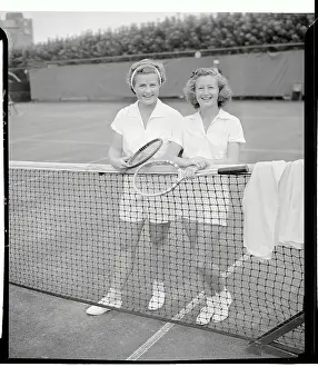 Competing Women Tennis Players Standing by Net