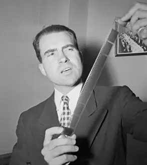 Congress Prints: Congressional Representative Richard Nixon Holding Microfilm Strips