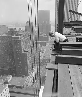 Construction Worker Looking over Building Edge