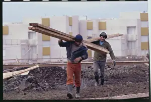 Golan Heights Prints: Construction Workers Carrying Railing near Complexes