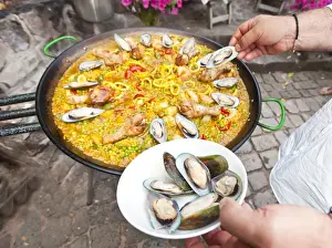Specialty Prints: Cook preparing a paella, a Spanish rice dish, adding mussels, series, no. 4