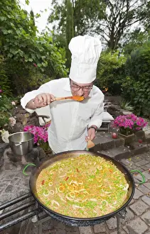 Specialty Prints: Cook preparing a paella, a Spanish rice dish, adding saffron, tasting, series, no. 1