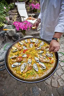 Specialty Prints: Cook preparing a paella, a Spanish rice dish, adding lemon, series, no. 6