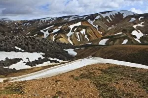 Cooled lava field with snow fields in a volcanic landscape, Landmannalaugar, Iceland, Europe