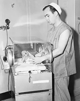 Corpsman Placing Baby into an Isolette