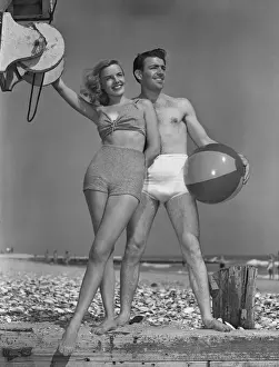 Couple on beach w / beach ball