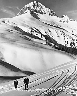Couple cross-country skiing in mountains