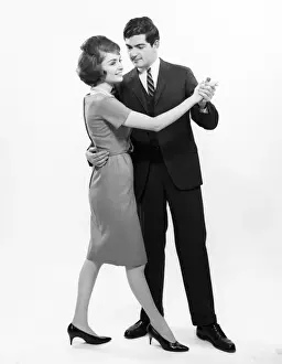 Mid Adult Couple Prints: Couple dancing, studio shot