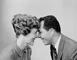 Couple, head to head, smiling and looking into each others eyes Couple, head to head, smiling and looking into each others eyes