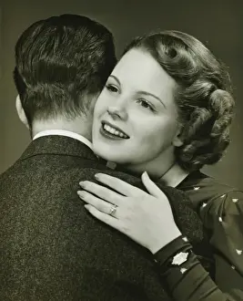 Mid Adult Couple Prints: Couple hugging in studio, (B&W), close-up, portrait