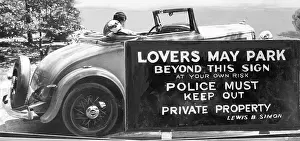 Advertising Sign Prints: Couple Kissing in Car near Regulatory Sign