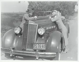 Couple Leaning on Automobile