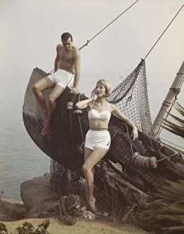 Iconic Bikini Collection: Couple leaning on boat at sea side