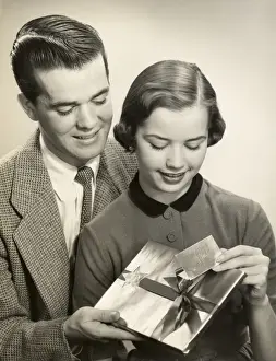 Couple opening gift