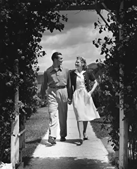 Couple outdoors holding hands while walking