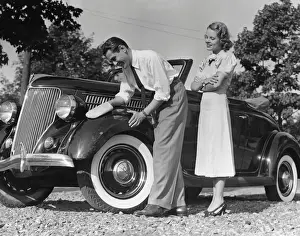 Couple polishing car