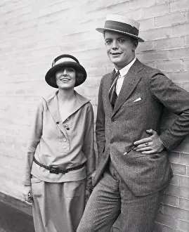 Couple Posing Against Wall