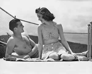 Couple relaxing on a sailboat