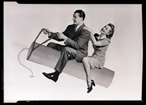 Couple Riding Fake Stick Of Dynamaite
