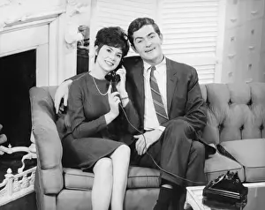 Side By Side Prints: Couple sitting on couch in living room, woman on phone, (B&W), portrait