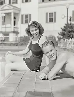 Swimwear Prints: Couple sitting by pool. (Photo by H. Armstrong Roberts / Retrofile / Getty Images)